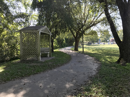 Benches in a gazebo on the walking path. The basketball court is in the distance. - Patton Park – Near Meadowbrook Log Cabin, Hendersonville ,NC