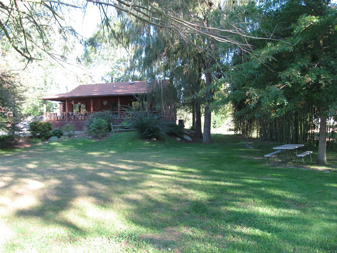 The grassy front yard is perfect for crocquet. Play horseshoes or bocci in the side yard.. The picnic table, under the oak is right next to the shallow brook.