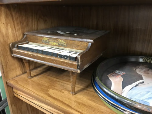 Little toy piano and some Coca Cola Memorabilia - Needful Things Antique Mall – Shopping near Meadowbrook Log Cabin, Hendersonville, NC