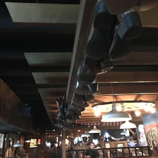 Boots hanging from the ceiling in Binions Roadhouse in Hendersonville, NC
